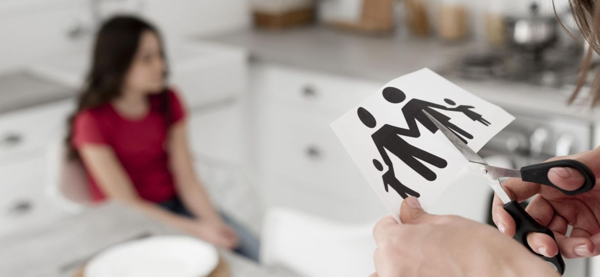 close-up-parent-cutting-paper-family-with-scissors