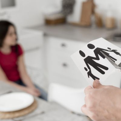 close-up-parent-cutting-paper-family-with-scissors